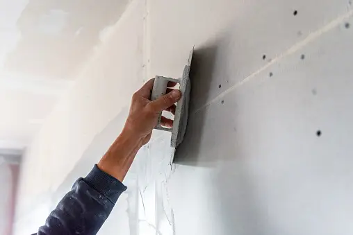 plastering a wall