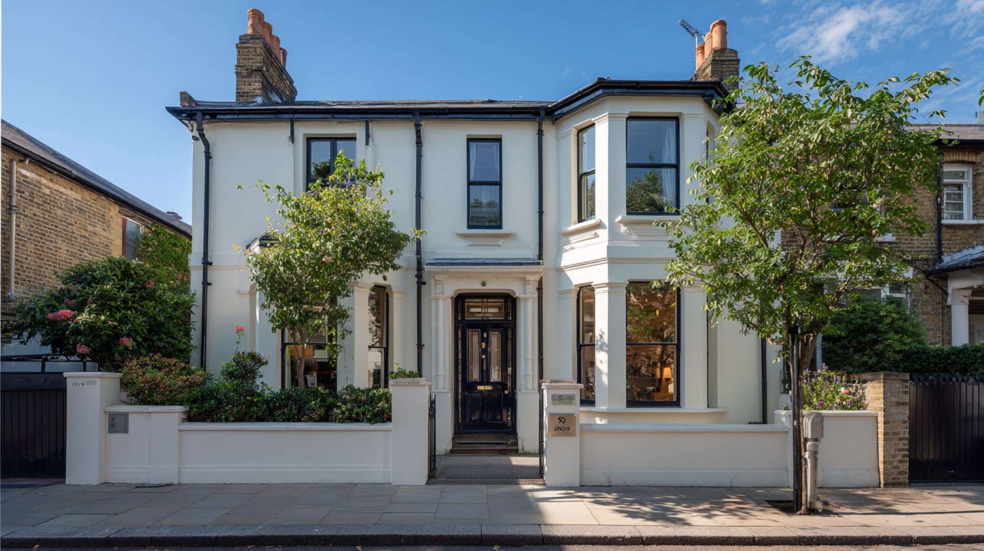 Classic cream house exterior protected with high-quality Exterior Wall Coatings for lasting beauty.