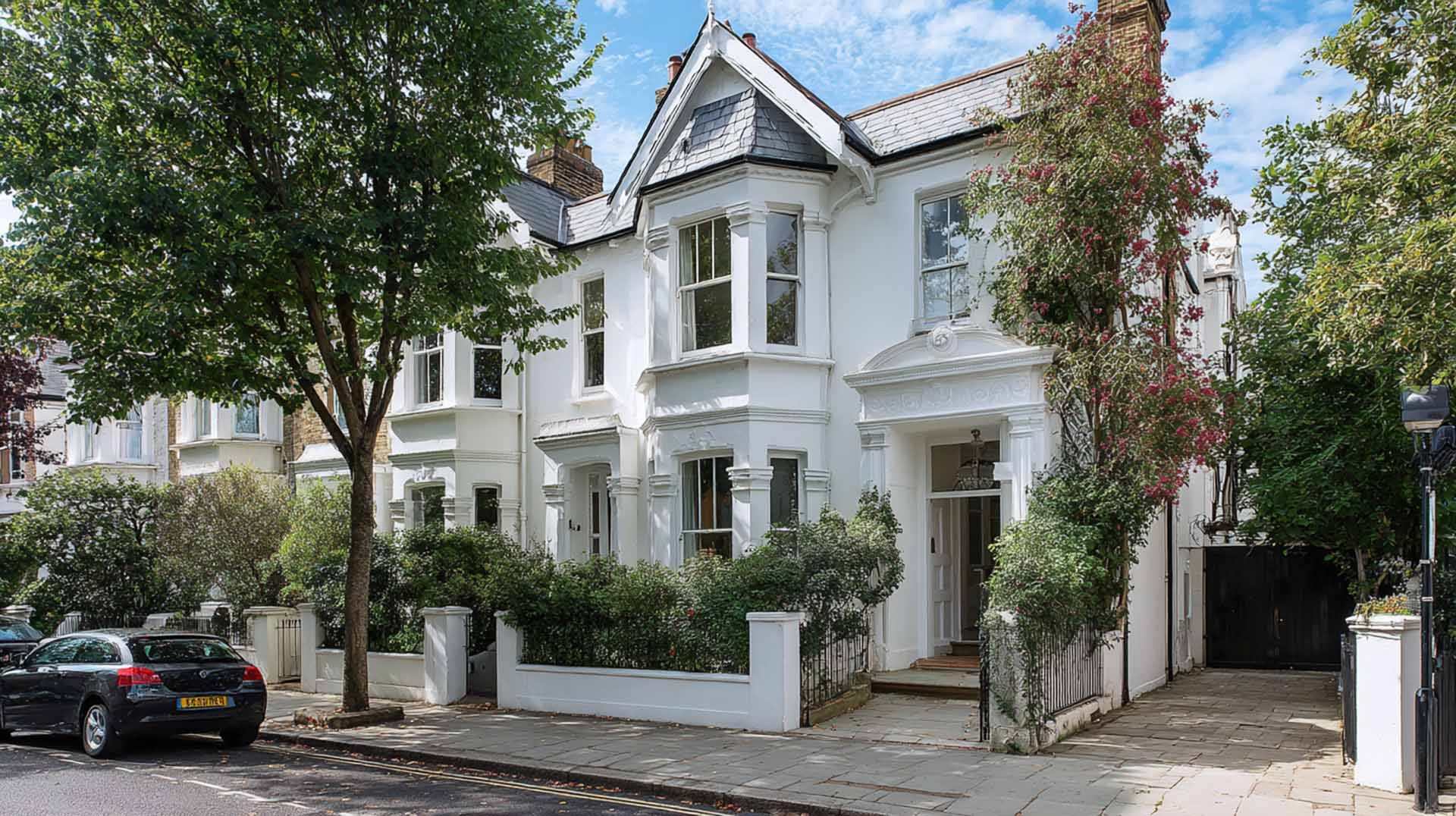 Victorian house exterior restored after repair of cracked external render, featuring clean white walls.