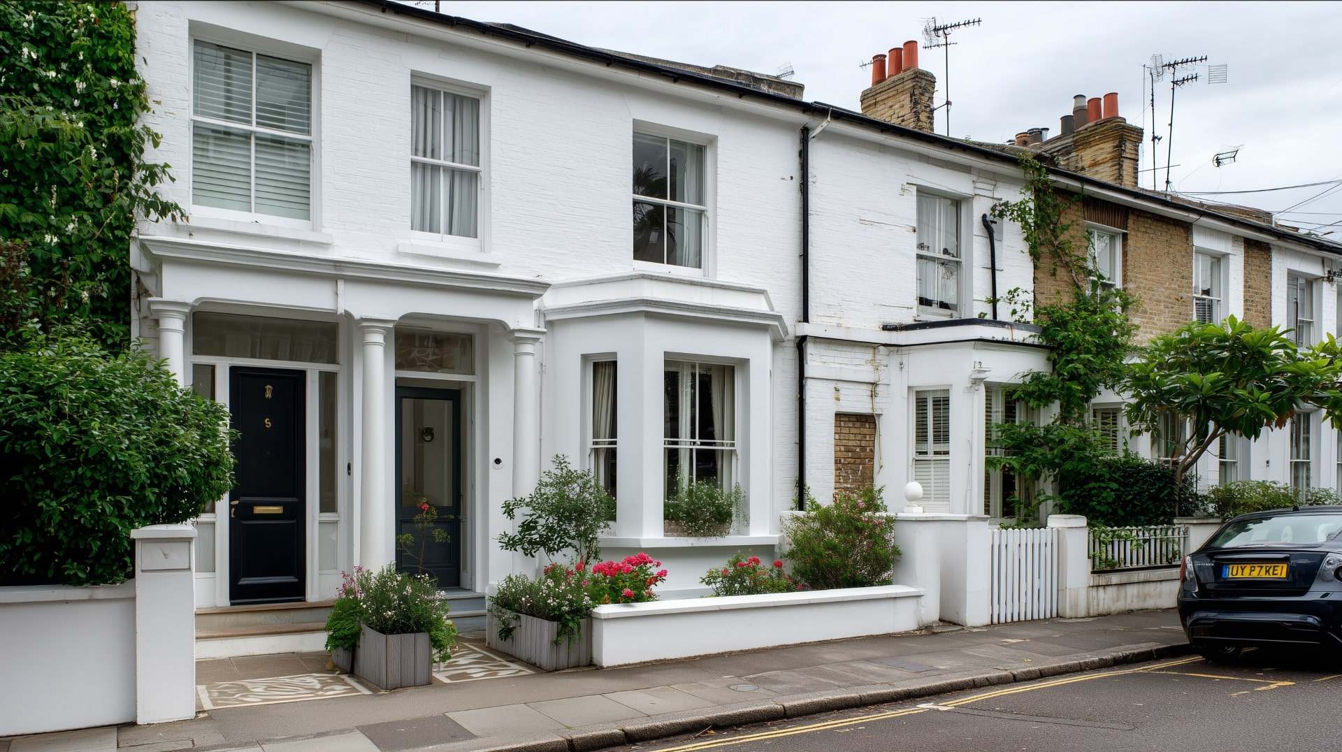 Restored terraced house with clean facade after blown render treatment.
